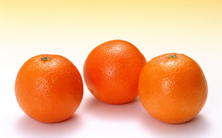 Three oranges white surface yellow - orange free wallpaper