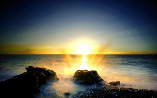 Sunset ocean rocks sky light - the foreground and a body of water free wallpaper