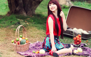 Woman sitting fruit basket outdoors - a blanket free wallpaper