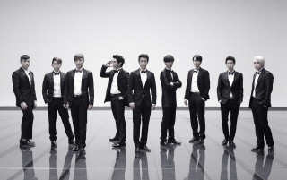 Men in suits standing formal - a wall in the background free wallpaper