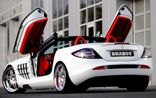 White mercedes sls red seats - a building in the background free wallpaper for desktop