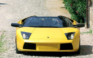 Yellow sports car cobblestone road - a yellow sports car free wallpaper