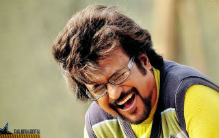 Man laughing glasses cellphone vest - movie still frame free wallpaper