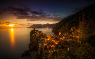Village cliff overlooking water night - andor basch free wallpaper