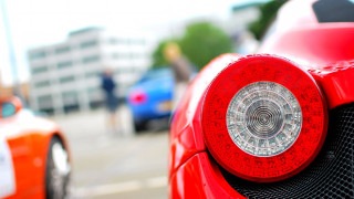 Red sports car person walking - a building in the background free wallpaper
