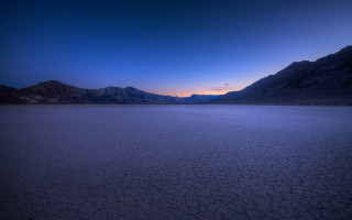 Mountainous ocean sunset cloudy sky - a large body of water free wallpaper