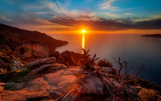 Sunset water tree cliff magic - a sunset over a body of water free wallpaper