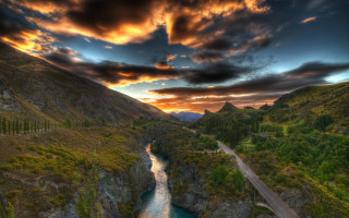 River valley bridge cityscape autumn - a lush green valley under a cloudy sky free wallpaper