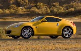Yellow sports car desert road - a dry grass field free wallpaper