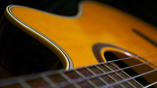 Guitar folkart yellowfretboard blurry depthoffield - a close up of a guitar free wallpaper