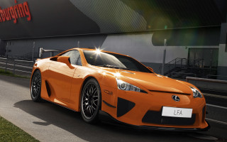 Orange sports car parked building - andrew law free wallpaper