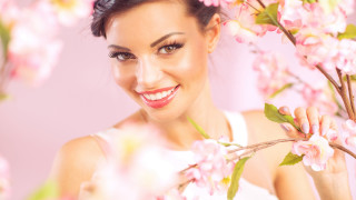 Woman smiling pink background flower - facial feature free wallpaper