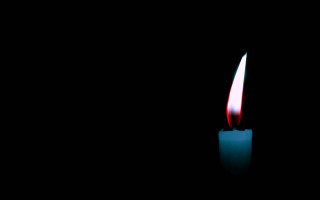 Lit candle red flame black - a red flame free wallpaper