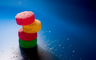 Colorful candies stack table blue - top of a table next free wallpaper