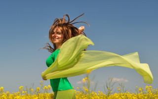 Woman field yellowflowers greenscarf smiling - a woman in a field free wallpaper