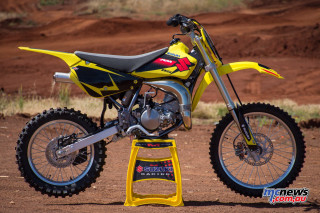 Yellow dirt bike parked stand - dusty free wallpaper