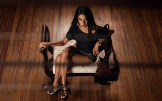Woman sitting crossed legs highheels 2 - a wooden floor free wallpaper