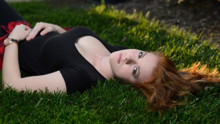 Woman laying on grass blurry 2 - the grass free wallpaper