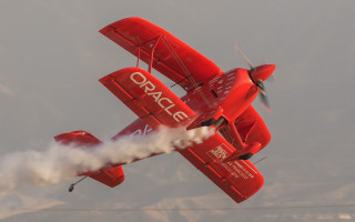 Red plane smoke wings mountains - the sky free wallpaper
