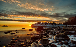 Sunset rocky beach boat snow - a sunset over a rocky beach free wallpaper