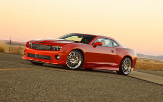 Red sports car sunset field - a sunset in the background free wallpaper