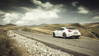 White car mountains cloudy sky - a mountain range in the background free wallpaper