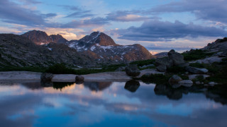 Mountain lake rocks snowy horizon - a lake in the foreground free wallpaper
