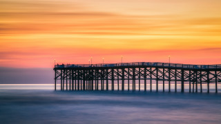 Pier lighthouse sunset ocean colorful - a colorful sky free wallpaper