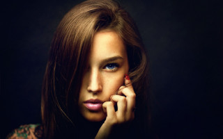 Woman redflower blackbackground blueeyes portrait - a red flower free wallpaper