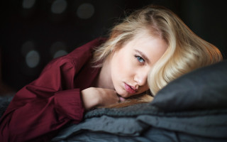 Woman laying bed serious blonde - free portrait wallpaper