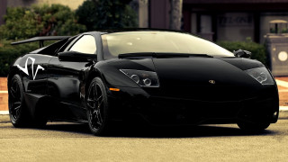 Black sports car clock building - the side of the road in front free wallpaper