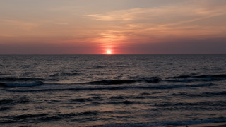 Sunset ocean waves beach person 3 - the beach in the distance free wallpaper