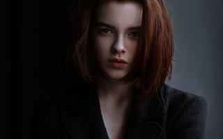 Woman redhair blackjacket serious portrait - a picture in the dark free wallpaper