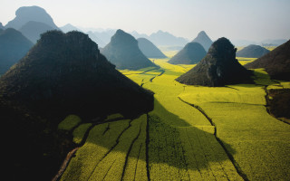 Mountain landscape trees fields clouds - a mountain range in the background free wallpaper