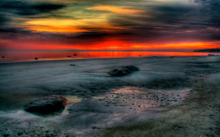 Mystical beach sunset rocks water - a few person free wallpaper