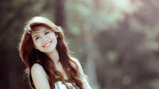 Woman long hair smiling forest - free portrait wallpaper