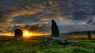 Sunset grassy field large rocks - bedwyr williams free wallpaper