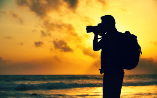 Beach sunset man camera ocean - the ocean in the background free wallpaper