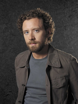 Man beard gray shirt posing - his hands in his pockets free wallpaper