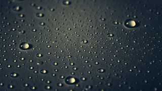 Water droplets macro rain night - a black surface free wallpaper