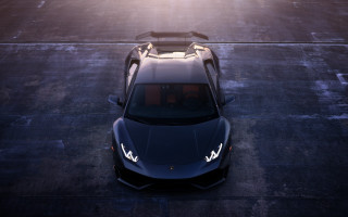 Black sports car sunlight shore - a parking lot free wallpaper