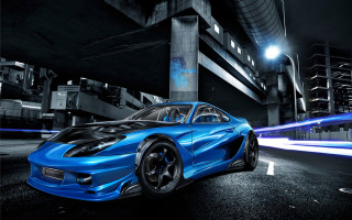 Blue sports car night street 3 - a building in the background free wallpaper