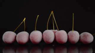 Pink fruit row black surface - a black surface free wallpaper