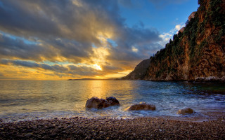 Sunset rocky beach cliff water - a sunset over a rocky beach free wallpaper