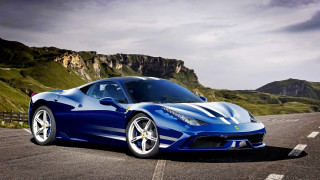 Blue sports car driving mountain - a mountain range in the background free wallpaper