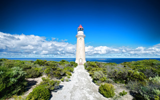 Lighthouse hill blue sky clouds - a path free wallpaper