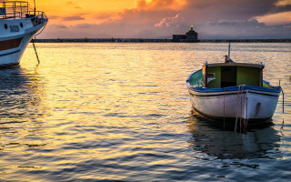 Boats lighthouse sunset water impressionist - a lighthouse in the distance free wallpaper