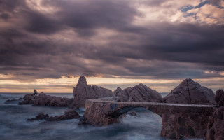Bridge water rocks cloudy sky - a bridge over a body of water free wallpaper