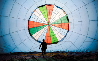 Man parachute fence rooftop tiles - a blue sky background free wallpaper