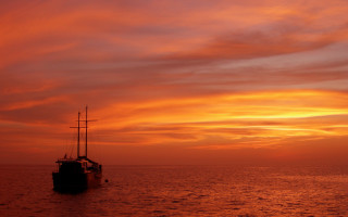 Boat sunset orange red clouds - a sky background free wallpaper for desktop
